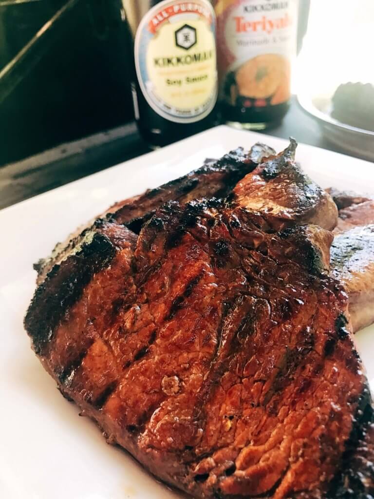 A quick and simple marinade that takes just a few minutes to put together. Perfect to leave overnight. The pineapple juice acid tenderizes the meat in a flavorful steak marinade. Great for any summer grilling, cook out, or BBQ event like 4th of July. Soy sauce, pineapple juice, ginger, and lime. Fast and easy dinner idea. Pineapple Soy Steaks | Three Olives Branch | www.threeolivesbranch.com