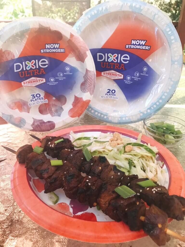 Simple steak skewers perfect for a summer BBQ or event like 4th of July, Memorial Day, and Labor Day. soy sauce, ginger, brown sugar, and more make a sticky marinade that is perfect for beef. Served with a tangy peanut slaw, this dish lets you have a delicious dinner with minimal effort. Use Dixie Ultra Plates for a quick cleanup! Kid friendly. Asian Steak Skewers with Peanut Slaw | Three Olives Branch | www.threeolivesbranch.com 