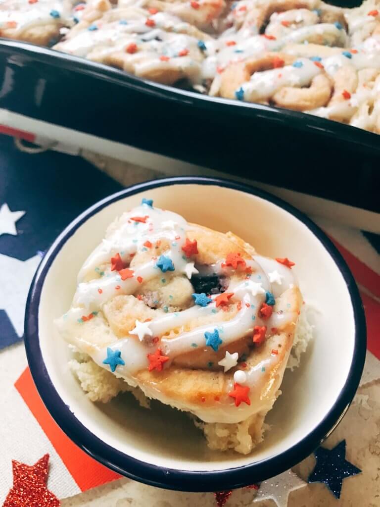 Red, white, and blue sweet rolls for a patriotic morning! A twist on cinnamon rolls, these are filled with cream cheese and mixed berries for a summer treat. Great for patriotic parties and BBQs like Labor Day, Memorial Day, and 4th of July. Make them in advance for a quick and easy breakfast or brunch to start the holiday. They even work as a dessert! Vegetarian and kid friendly. Patriotic Berry Sweet Rolls | Three Olives Branch | www.threeolivesbranch.om