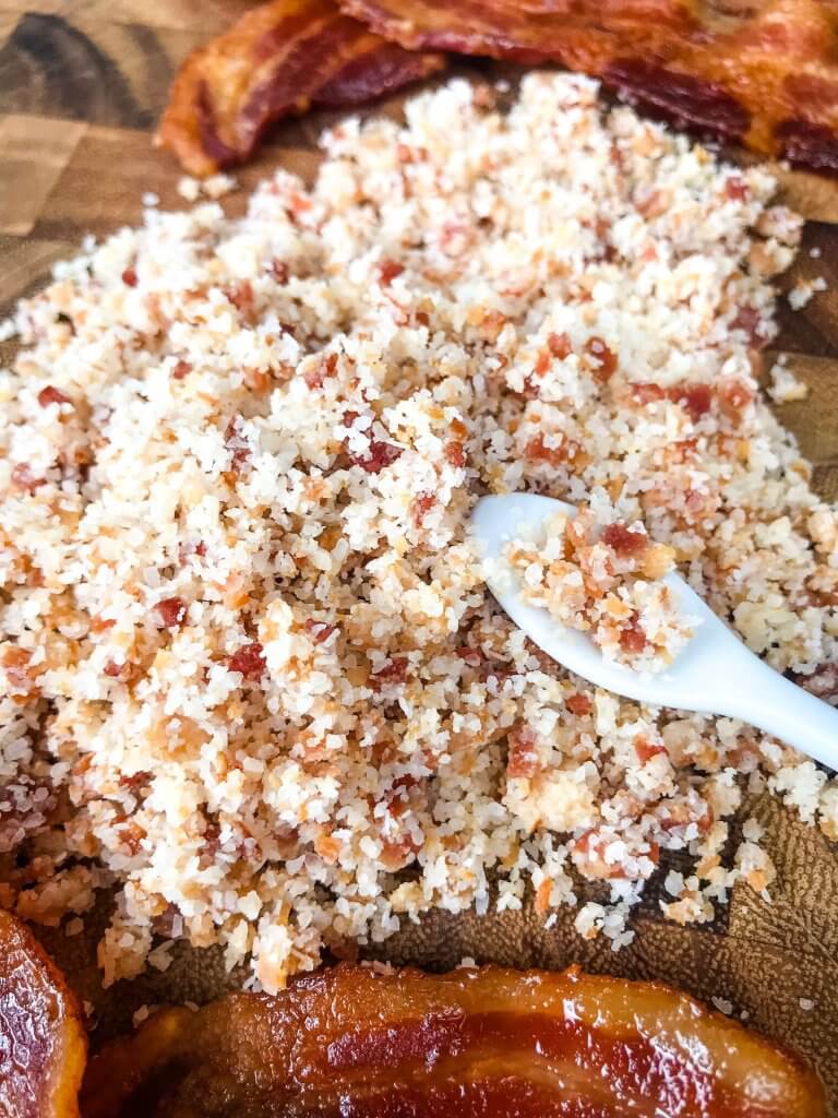 A pile of bacon salt with a small spoon in it
