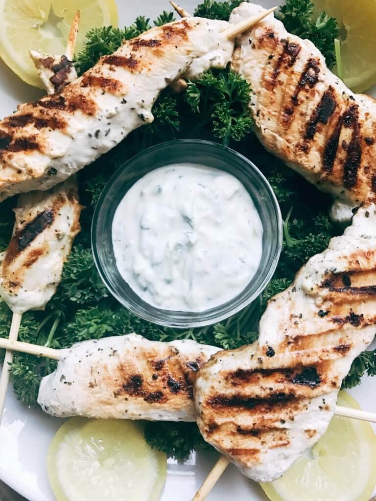 A quick and simple grilled chicken for summer and game day. Chicken is marinated in a mixture of Greek yogurt, lemon, and oregano and grilled. Great on salads, in gyros, wraps, as a main course, and more! Easy and fast to make, a fresh. simple, and light meal. Oregano Lemon Yogurt Greek Chicken Skewers | Three Olives Branch | www.threeolivesbranch.com