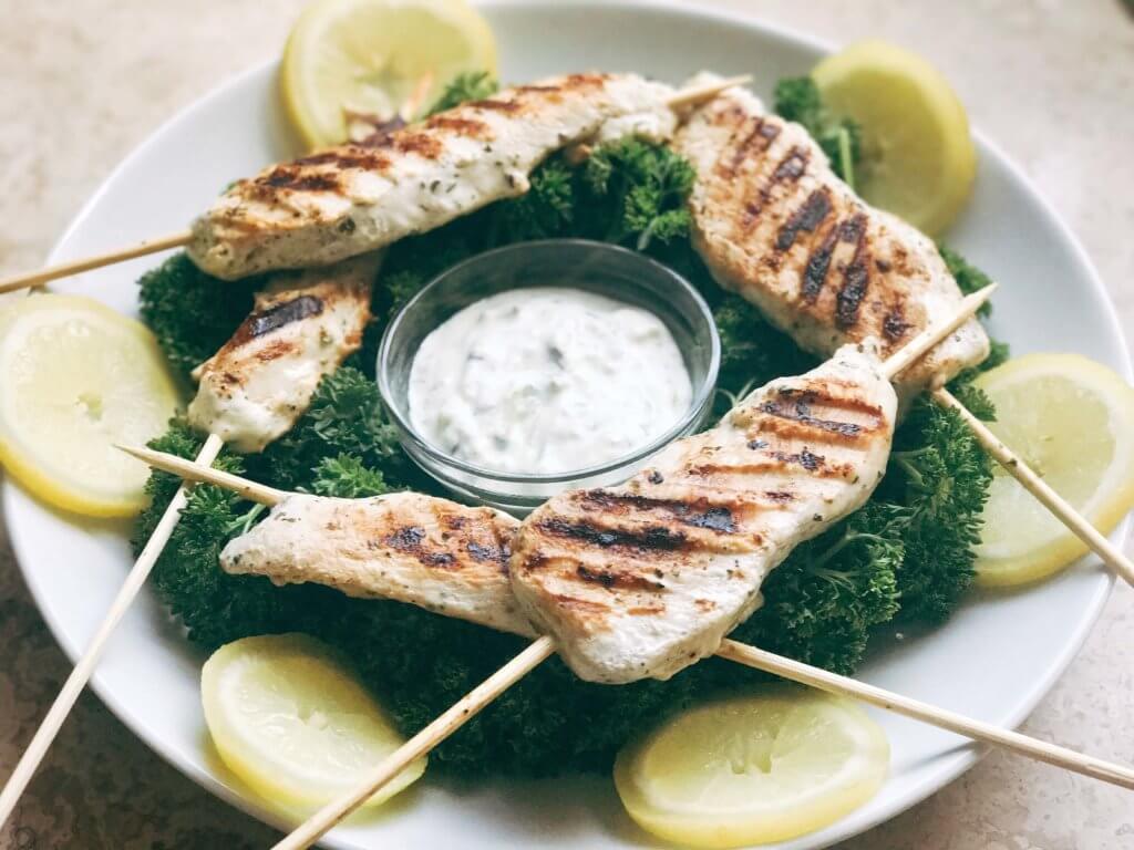 A quick and simple grilled chicken for summer and game day. Chicken is marinated in a mixture of Greek yogurt, lemon, and oregano and grilled. Great on salads, in gyros, wraps, as a main course, and more! Easy and fast to make, a fresh. simple, and light meal. Oregano Lemon Yogurt Greek Chicken Skewers | Three Olives Branch | www.threeolivesbranch.com