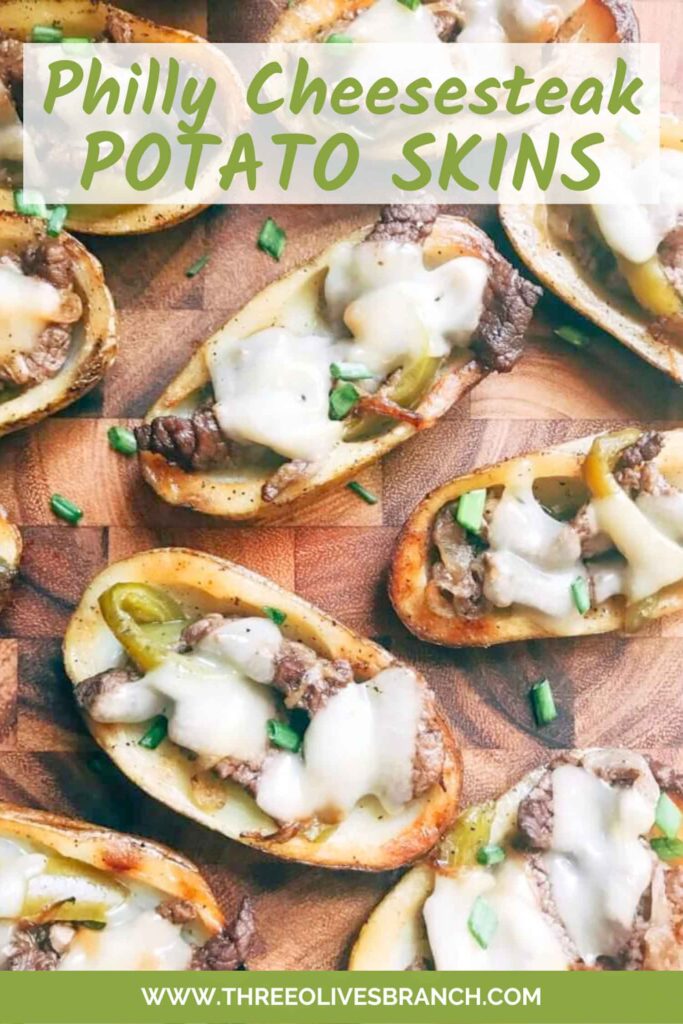 Pin of Philly Cheesesteak Potato Skins sitting on a wood cutting board with title at top