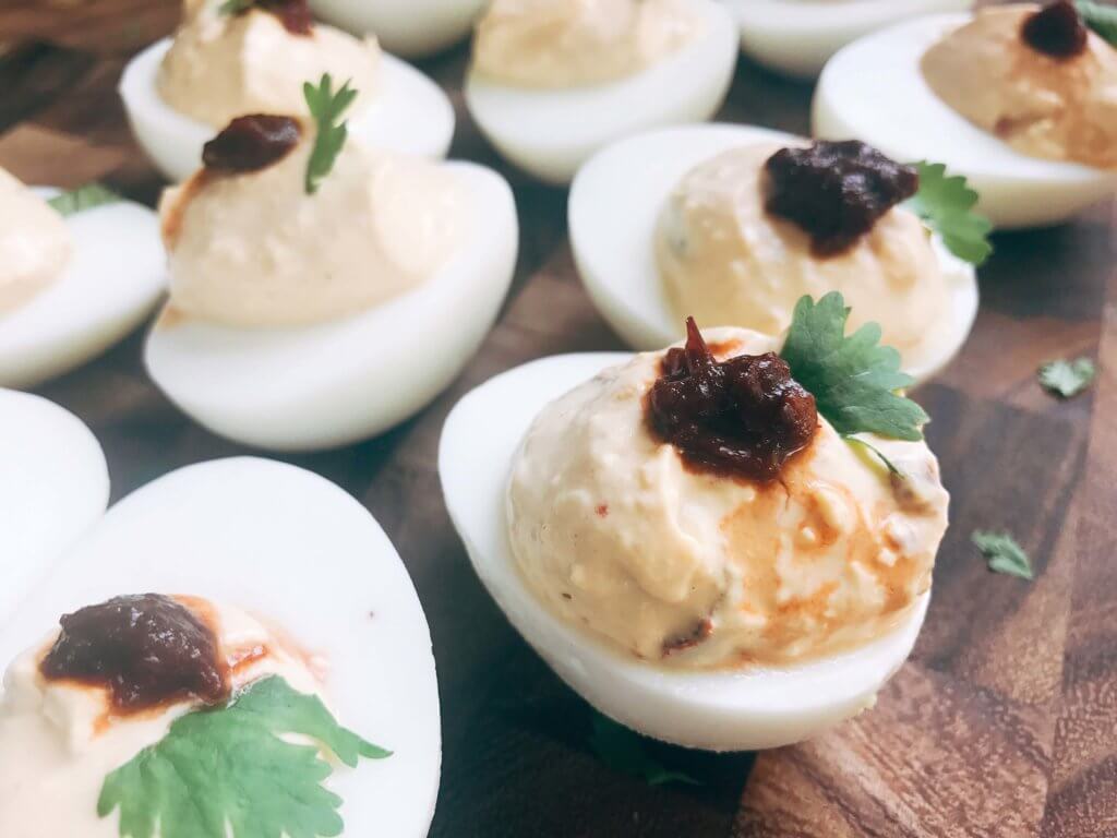 Ready in less than 10 minutes, this deviled egg recipe is a fun twist on a classic appetizer. Chipotle peppers in adobo and lime juice give Mexican food flare to the deviled egg. Simple, fast, and easy to make. Vegetarian and gluten free. A great party snack for game day or holiday events and party gatherings. Chipotle Lime Deviled Eggs | Three Olives Branch | www.threeolivesbranch.com