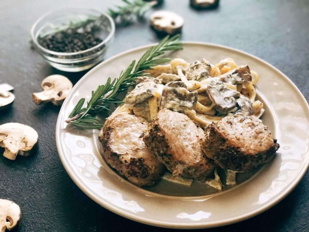25 minutes to makes these marinated pork medallions and creamy mushroom pasta. Smithfield Roasted Garlic and Cracked Peppercorn Tenderloin Marinated Pork is a quick and easy meal solution for busy families any night of the week. The pasta is made from cream, mushrooms, garlic, and cracked black pepper. Fast, simple, and easy comfort food. Pork Medallions with Creamy Peppercorn Mushroom Pasta | Three Olives Branch | www.threeolivesbranch.com