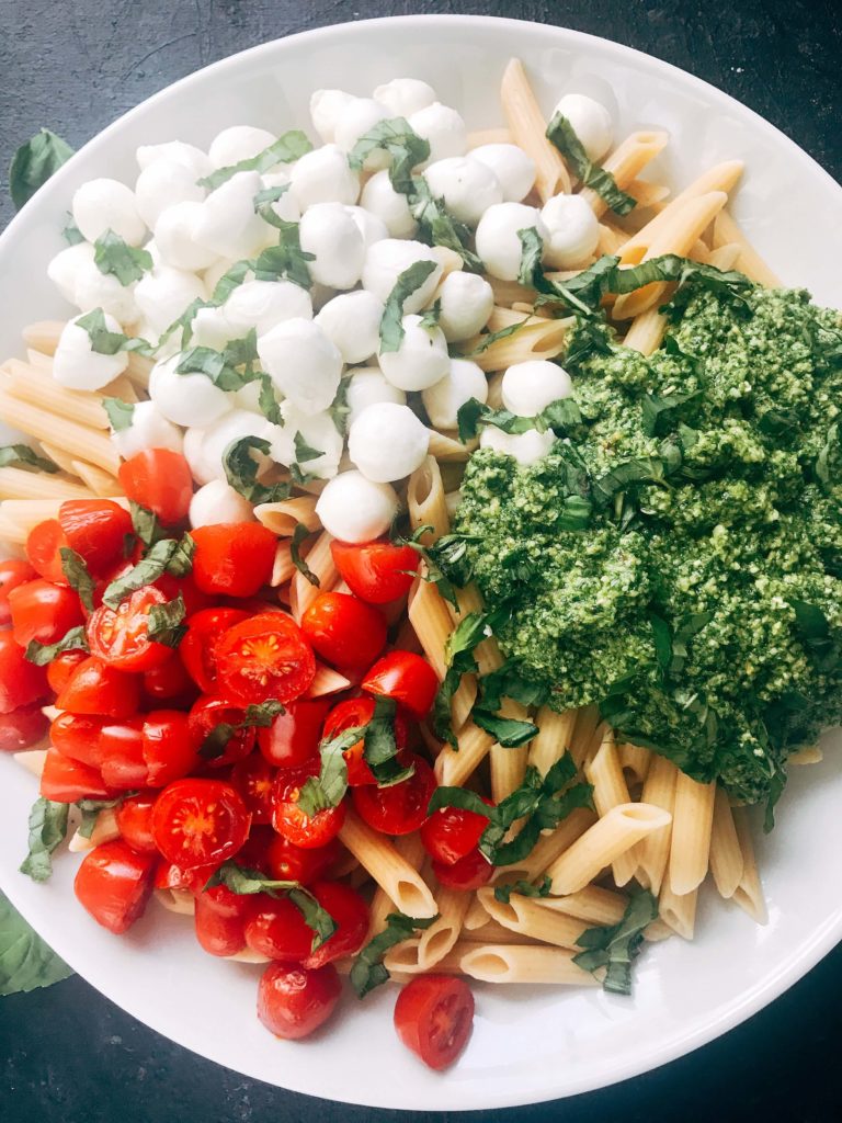 Less than 25 minutes to make this fresh basil pesto pasta with cherry tomatoes and fresh mozzarella cheese. A quick and simple Italian pasta recipe highlighting fresh caprese flavors. Vegetarian recipe but add chicken or sausage for the meat lovers. Featuring Barilla ProteinPLUS pasta, this dinner recipe is nutritious and hearty, packed with protein, fiber, and Omega-3. Pesto Caprese Penne Pasta | Three Olives Branch | www.threeolivesbranch.com