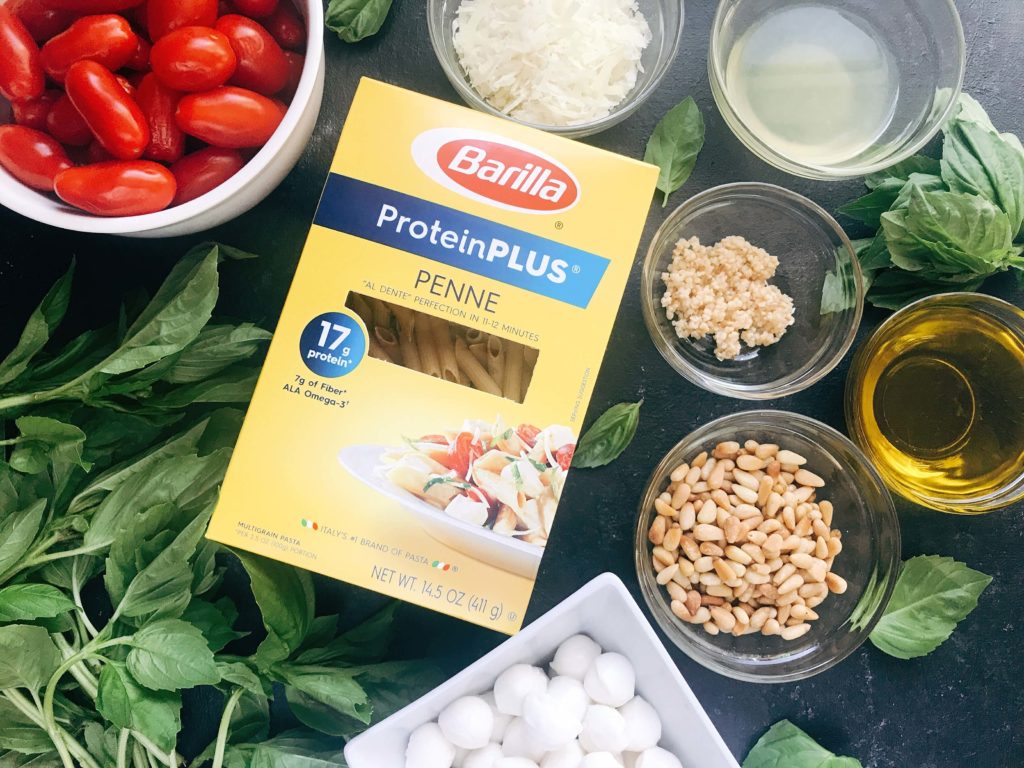 Less than 25 minutes to make this fresh basil pesto pasta with cherry tomatoes and fresh mozzarella cheese. A quick and simple Italian pasta recipe highlighting fresh caprese flavors. Vegetarian recipe but add chicken or sausage for the meat lovers. Featuring Barilla ProteinPLUS pasta, this dinner recipe is nutritious and hearty, packed with protein, fiber, and Omega-3. Pesto Caprese Penne Pasta | Three Olives Branch | www.threeolivesbranch.com