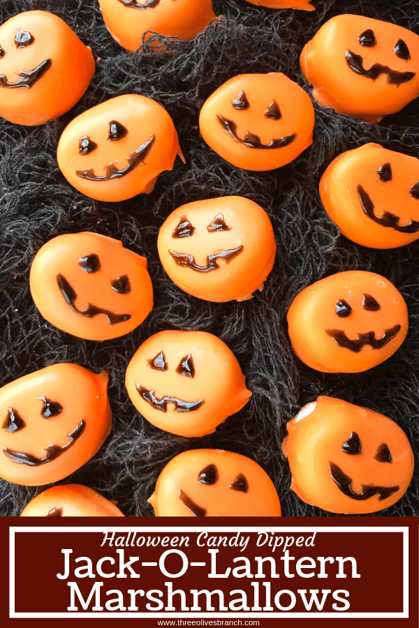 Candy pumpkin marshmallows, perfect for Halloween! Marshmallows are coated in melted orange candy with black piping gel for their jack-o-lantern faces. A fun dessert treat to make for Halloween parties. Halloween Candy Dipped Jack-O-Lantern Pumpkin Marshmallows | Three Olives Branch | www.threeolivesbranch.com #halloween #marshmallow #pumpkin #jackolantern