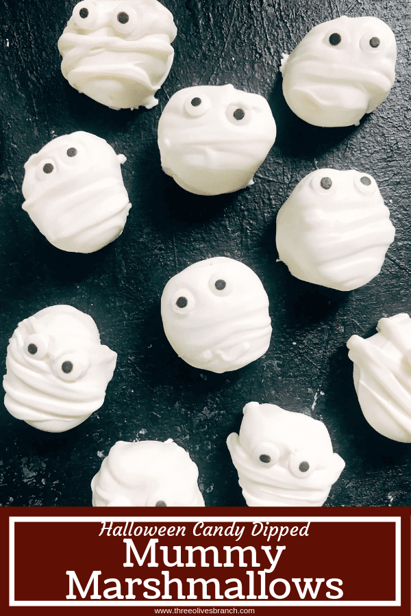 15 minutes to make these quick and simple mummy marshmallows! Large marshmallows are cut in half, covered in white candy melt with mummy wraps, and small candy eyes. Perfect for Halloween parties and a favorite among kids. Halloween Mummy Candy Dipped Marshmallows #halloweenrecipes #halloweendessert #mummyrecipe