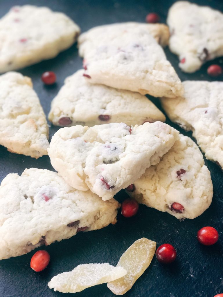 Classic holiday flavors in a scone. Fresh or frozen cranberries and crystallized ginger are mixed into a scone recipe for a breakfast or brunch that is perfect for the holidays. Cranberries and ginger are perfect for Thanksgiving and Christmas. These scones can be easily frozen and baked as needed. Candied ginger brings a sweet and spicy flavor. Vegetarian. Cranberry Ginger Scones | Three Olives Branch | www.threeolivesbranch.com