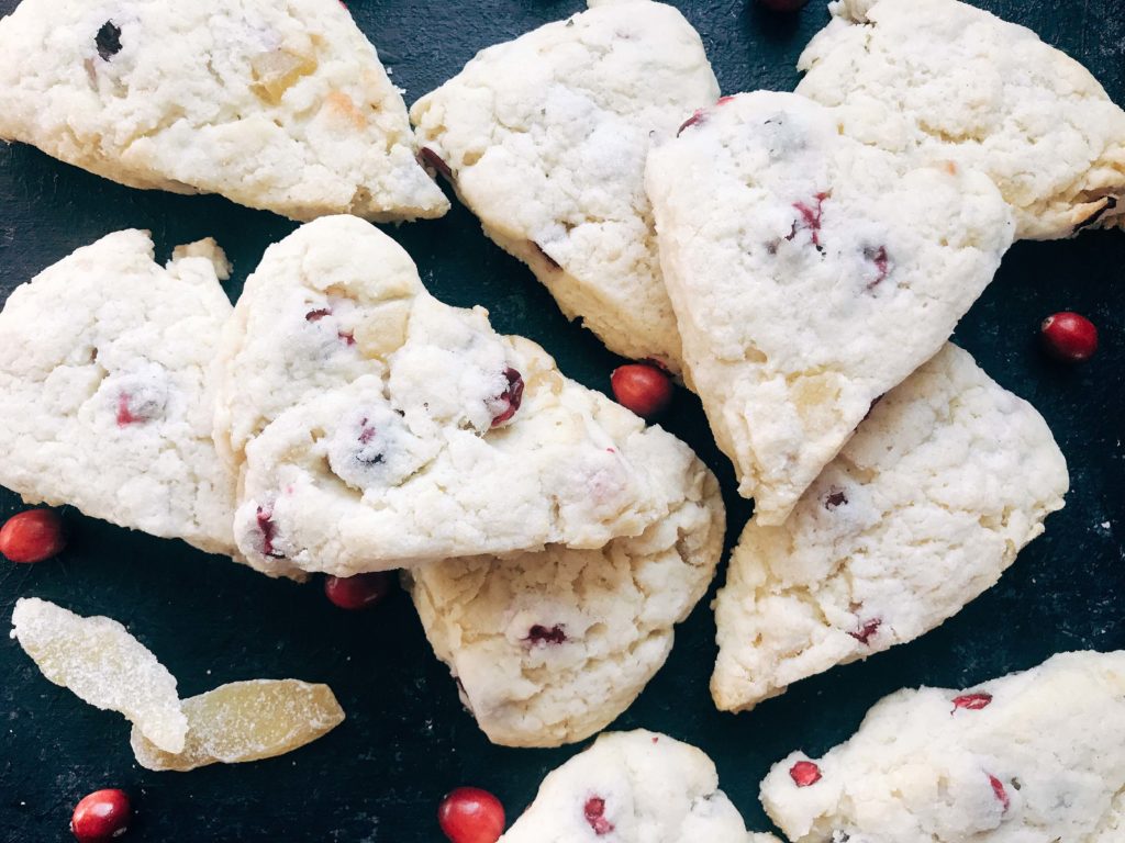 Classic holiday flavors in a scone. Fresh or frozen cranberries and crystallized ginger are mixed into a scone recipe for a breakfast or brunch that is perfect for the holidays. Cranberries and ginger are perfect for Thanksgiving and Christmas. These scones can be easily frozen and baked as needed. Candied ginger brings a sweet and spicy flavor. Vegetarian. Cranberry Ginger Scones | Three Olives Branch | www.threeolivesbranch.com