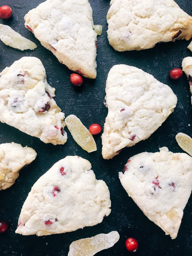 Classic holiday flavors in a scone. Fresh or frozen cranberries and crystallized ginger are mixed into a scone recipe for a breakfast or brunch that is perfect for the holidays. Cranberries and ginger are perfect for Thanksgiving and Christmas. These scones can be easily frozen and baked as needed. Candied ginger brings a sweet and spicy flavor. Vegetarian. Cranberry Ginger Scones | Three Olives Branch | www.threeolivesbranch.com