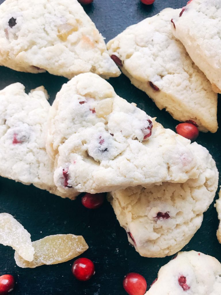 Classic holiday flavors in a scone. Fresh or frozen cranberries and crystallized ginger are mixed into a scone recipe for a breakfast or brunch that is perfect for the holidays. Cranberries and ginger are perfect for Thanksgiving and Christmas. These scones can be easily frozen and baked as needed. Candied ginger brings a sweet and spicy flavor. Vegetarian. Cranberry Ginger Scones | Three Olives Branch | www.threeolivesbranch.com