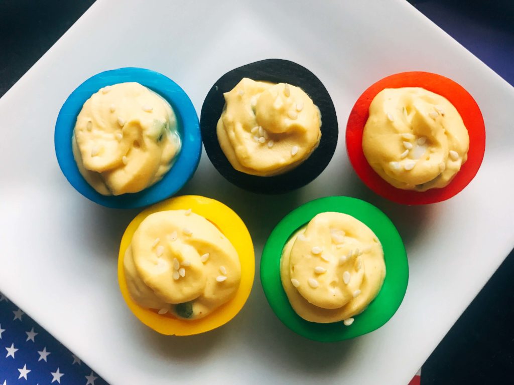 Korean flavored deviled eggs in time for the 2018 Winter Olympics! This deviled egg recipe is fast, easy, and simple to make. Korean flavors of chile pepper, soy, and sesame in honor of the host city. Vegetarian and gluten free. Korean Olympic Ring Deviled Eggs | Three Olives Branch | www.threeolivesbranch.com #olympicrecipe #glutenfree #olympicrings