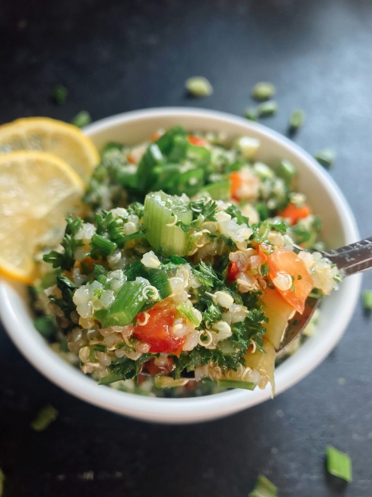 Ready in 15-20 minutes, this tabbouleh is perfect as a side or lunch. Fresh parsley, green onion, tomatoes, lemon, and mint are mixed with quinoa for a twist on classic tabouleh (tabouli). Vegan, vegetarian, gluten free. Vegan Quinoa Tabbouleh | Three Olives Branch | www.threeolivesbranch.com #vegan #tabbouleh #healthy