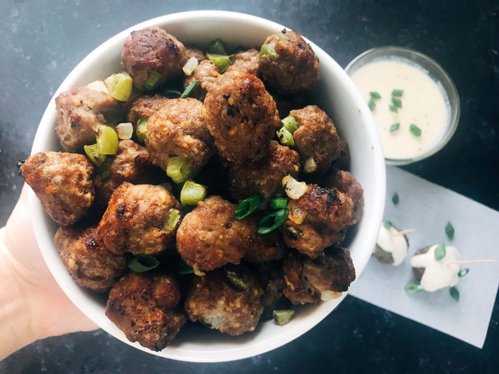 Beef meatballs mixed with green bell pepper and onion, served with a provolone cheese dipping sauce. Traditional Philly Cheesesteak flavors in meatball form. Perfect for game day, especially rooting for the Philadelphia Eagles, and the Super Bowl. Simple to make. Philly Cheesesteak Meatballs | Three Olives Branch | www.threeolivesbranch.com #superbowl #appetizer #meatball #gameday #football