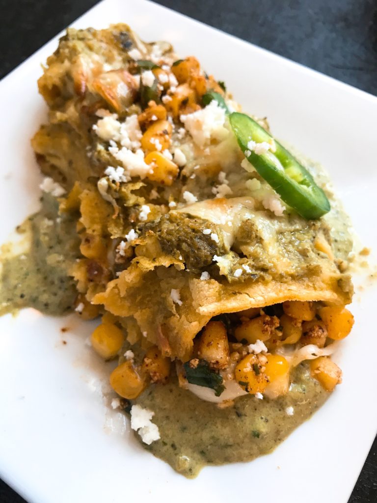 Corn, jalapeno peppers, cilantro, lime, chili powder, and cotija cheese are combined to make a Mexican Street Corn (elote) salsa that is the star of these enchiladas.. Layered with Monterey Jack cheese and topped with Roasted Poblano and Lime Enchilada Sauce. Vegetarian. Mexican Street Corn Enchiladas | Three Olives Branch | www.threeolivesbranch.com #vegetarian #mexican #enchiladas