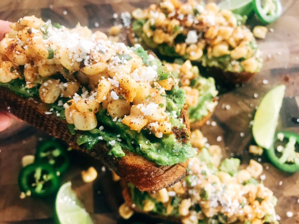 Fast and simple avocado toast topped with Mexican Street Corn Salsa. Quick breakfast, lunch, or snack recipe. Elote flavors of corn, cotija, chili powder, lime, cilantro, and jalapeno make a flavorful salsa. Vegetarian. Mexican Street Corn Avocado Toast | Three Olives Branch | www.threeolivesbranch.com