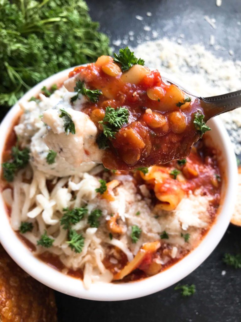 A hearty soup perfect for your crock pot on busy and cold nights. Simple and easy to prepare, this soup is topped with herbed ricotta cheese for classic Italian comfort food in a bowl. Slow Cooker Vegetarian Lentil Lasagna Soup | Three Olives Branch | www.threeolivesbranch.com #italianfood #slowcookersoup #lasagna #vegetarianrecipe