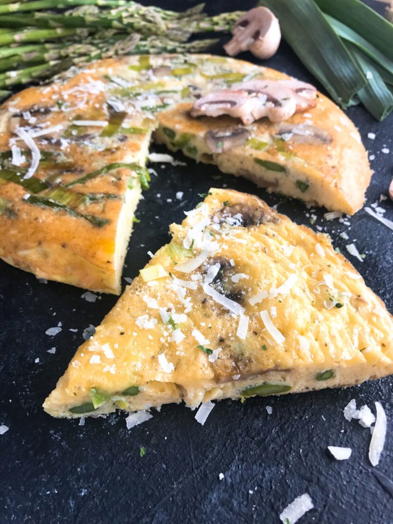 A quick and simple breakfast or brunch recipe ready in 20 minutes. Vegetarian, low carb keto, and gluten free, this frittata is similar to an omelette and perfect for holidays like Easter and feeding a crowd. Asparagus, Leek, and Mushroom Parmesan Frittata #breakfastrecipe #vegetarianbreakfast #easterbrunch #springbreakfast