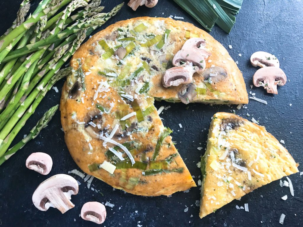 A quick and simple breakfast or brunch recipe ready in 20 minutes. Vegetarian, low carb keto, and gluten free, this frittata is similar to an omelette and perfect for holidays like Easter and feeding a crowd. Asparagus, Leek, and Mushroom Parmesan Frittata #breakfastrecipe #vegetarianbreakfast #easterbrunch #springbreakfast