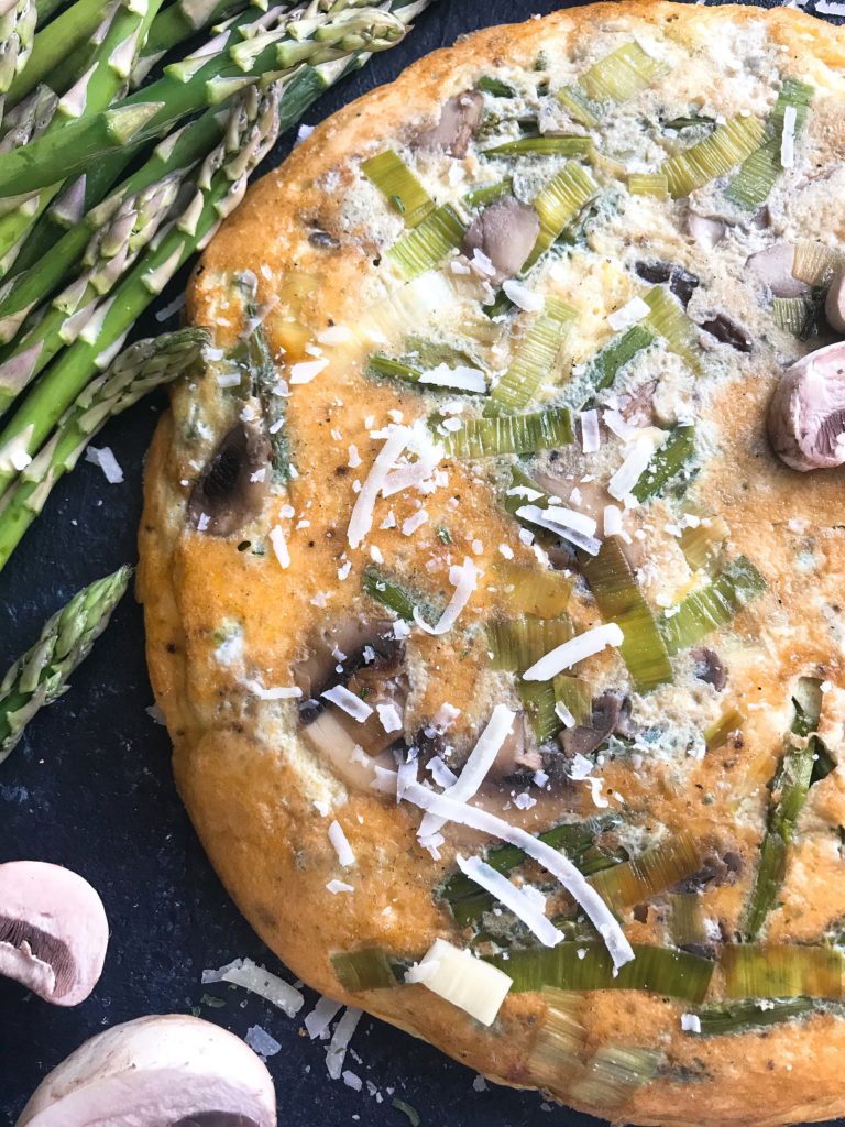 A quick and simple breakfast or brunch recipe ready in 20 minutes. Vegetarian, low carb keto, and gluten free, this frittata is similar to an omelette and perfect for holidays like Easter and feeding a crowd. Asparagus, Leek, and Mushroom Parmesan Frittata #breakfastrecipe #vegetarianbreakfast #easterbrunch #springbreakfast