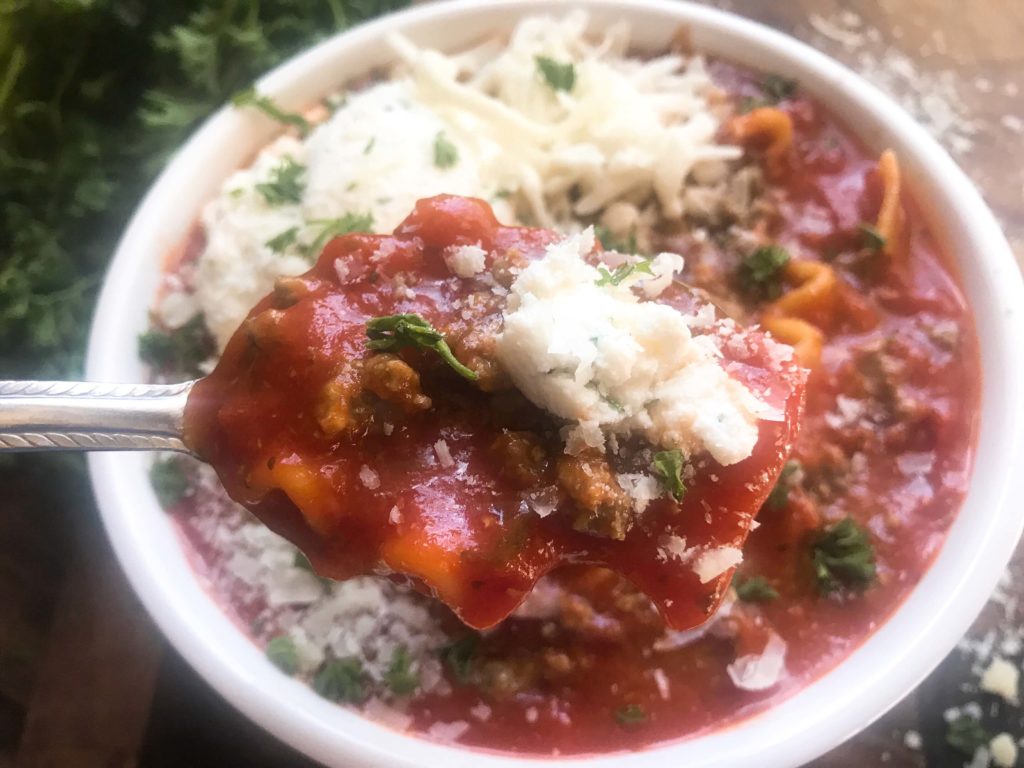 A hearty soup recipe perfect for your crock pot on busy and cold nights. Simple and easy to prepare, this soup is topped with herbed ricotta cheese for classic Italian comfort food in a bowl. Slow Cooker Beef Lasagna Soup | Three Olives Branch | www.threeolivesbranch.com #italianfood #slowcookersoup #lasagna