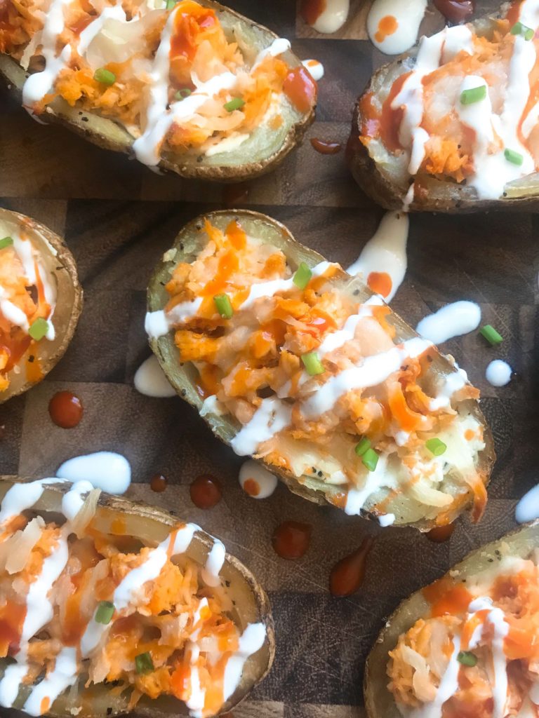 Two classic game day appetizers combined in one. Potato skin shells filled with three cheeses and buffalo chicken. A perfect party recipe for the Super Bowl or sporting event. Gluten free (gf). Buffalo Chicken Potato Skins | Three Olives Branch | www.threeolivesbranch.com #gameday #superbowl #appetizer