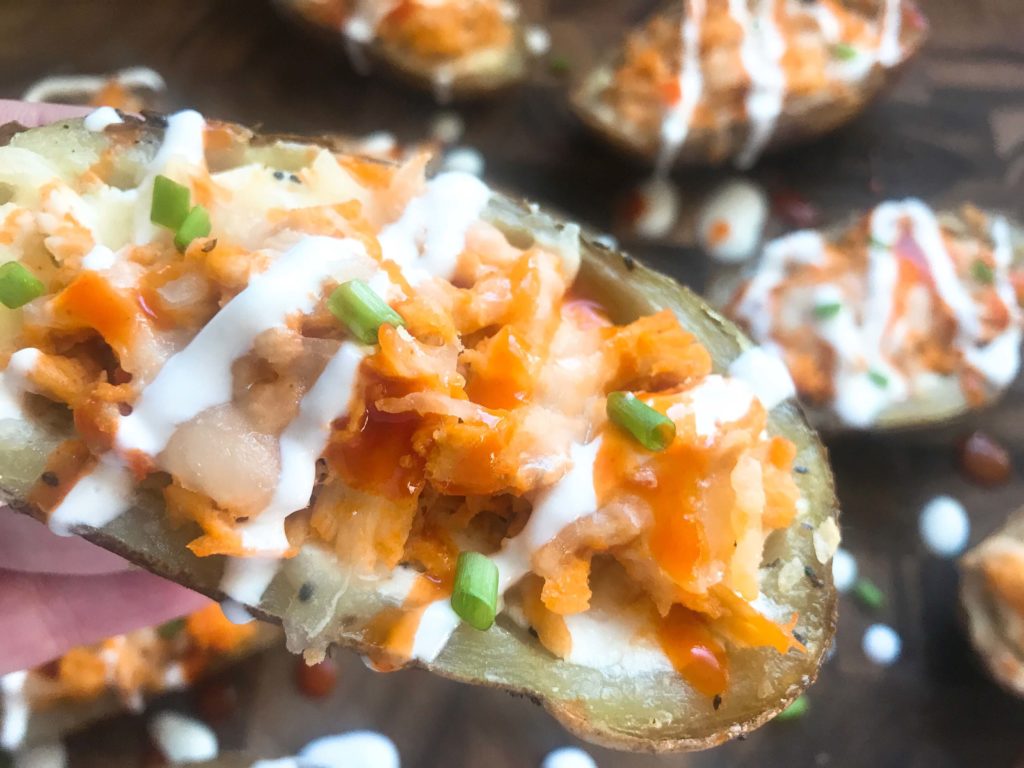 Two classic game day appetizers combined in one. Potato skin shells filled with three cheeses and buffalo chicken. A perfect party recipe for the Super Bowl or sporting event. Gluten free (gf). Buffalo Chicken Potato Skins | Three Olives Branch | www.threeolivesbranch.com #gameday #superbowl #appetizer