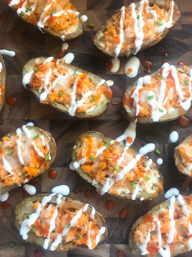 Two classic game day appetizers combined in one. Potato skin shells filled with three cheeses and buffalo chicken. A perfect party recipe for the Super Bowl or sporting event. Gluten free (gf). Buffalo Chicken Potato Skins | Three Olives Branch | www.threeolivesbranch.com #gameday #superbowl #appetizer