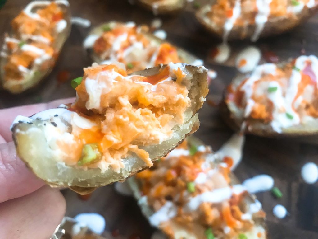 Two classic game day appetizers combined in one. Potato skin shells filled with three cheeses and buffalo chicken. A perfect party recipe for the Super Bowl or sporting event. Gluten free (gf). Buffalo Chicken Potato Skins | Three Olives Branch | www.threeolivesbranch.com #gameday #superbowl #appetizer