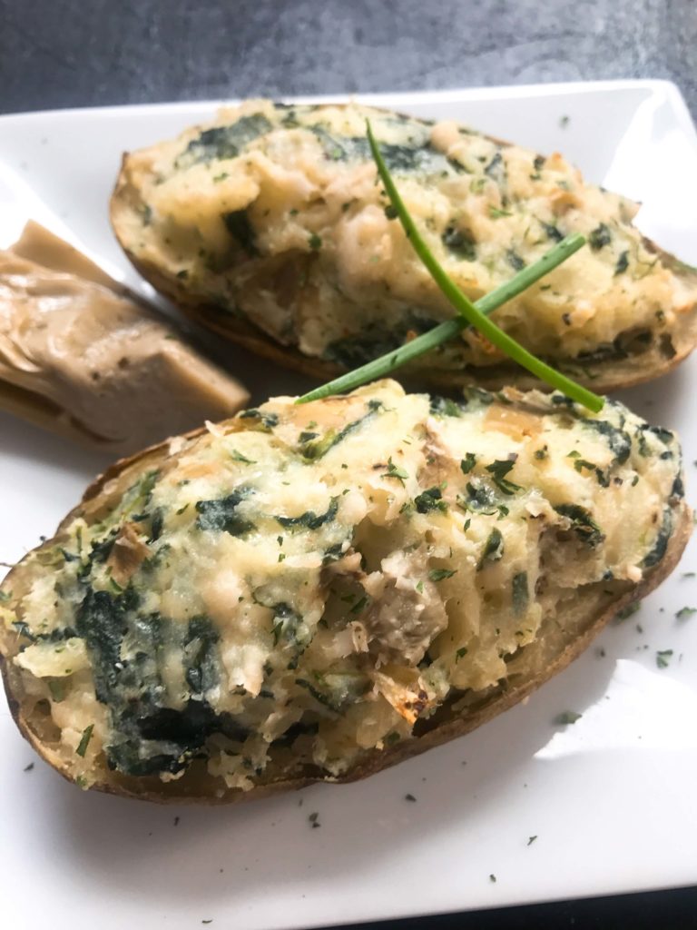 Spinach, artichoke, Parmesan, cream cheese, and spices flavor these twice baked potatoes as a perfect side dish. Vegetarian and gluten free (GF), these potatoes are a fun and unique recipe to get out of your boring recipe rut. Spinach Artichoke Stuffed Potatoes | Three Olives Branch | www.threeolivesbranch.com