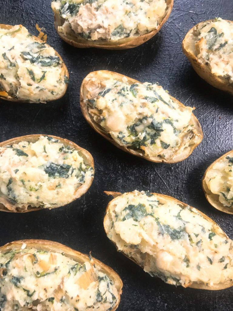 Spinach, artichoke, Parmesan, cream cheese, and spices flavor these twice baked potatoes as a perfect side dish. Vegetarian and gluten free (GF), these potatoes are a fun and unique recipe to get out of your boring recipe rut. Spinach Artichoke Stuffed Potatoes | Three Olives Branch | www.threeolivesbranch.com