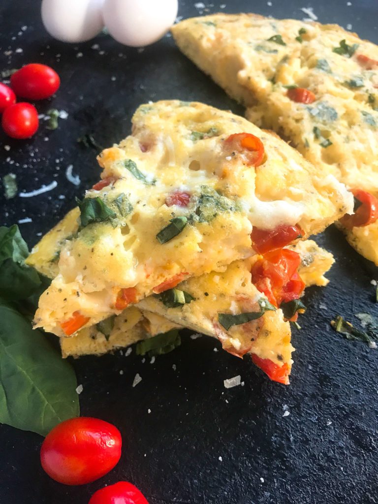 A fresh and bright frittata recipe ready in less than 30 minutes. Fresh cherry tomatoes, mozzarella cheese, and basil pack this egg frittata with flavor. Gluten free (GF) and vegetarian, a simple breakfast or brunch for a crown. Caprese Frittata | Three Olives Branch | www.threeolivesbranch.com 