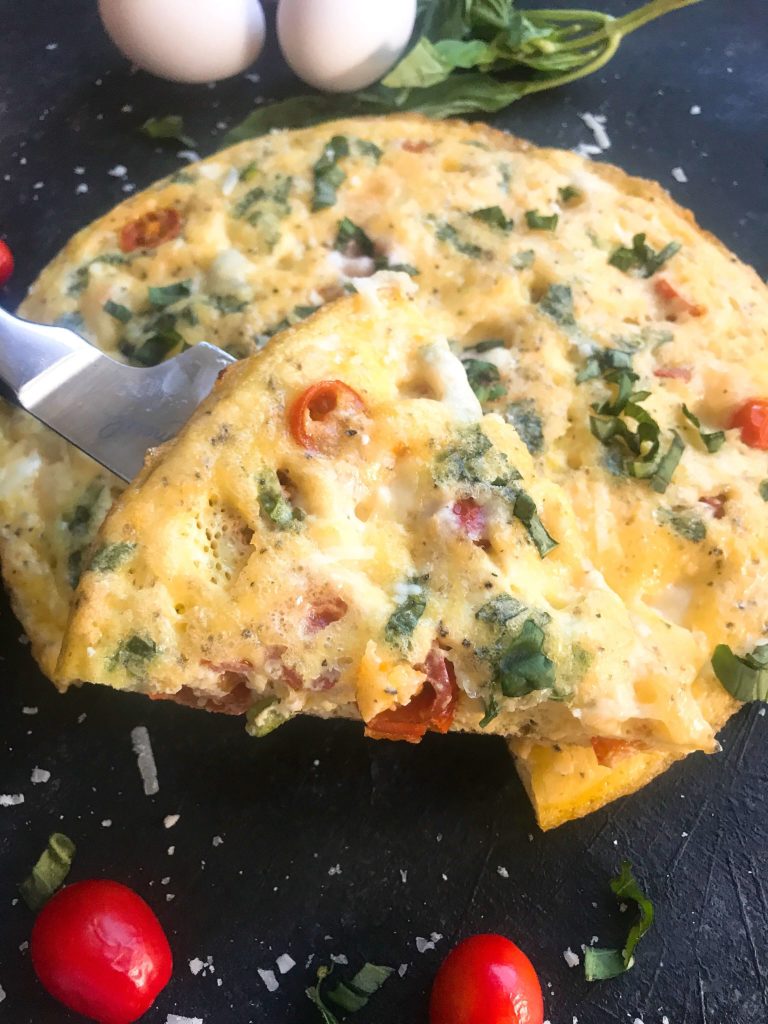 A fresh and bright frittata recipe ready in less than 30 minutes. Fresh cherry tomatoes, mozzarella cheese, and basil pack this egg frittata with flavor. Gluten free (GF) and vegetarian, a simple breakfast or brunch for a crown. Caprese Frittata | Three Olives Branch | www.threeolivesbranch.com 