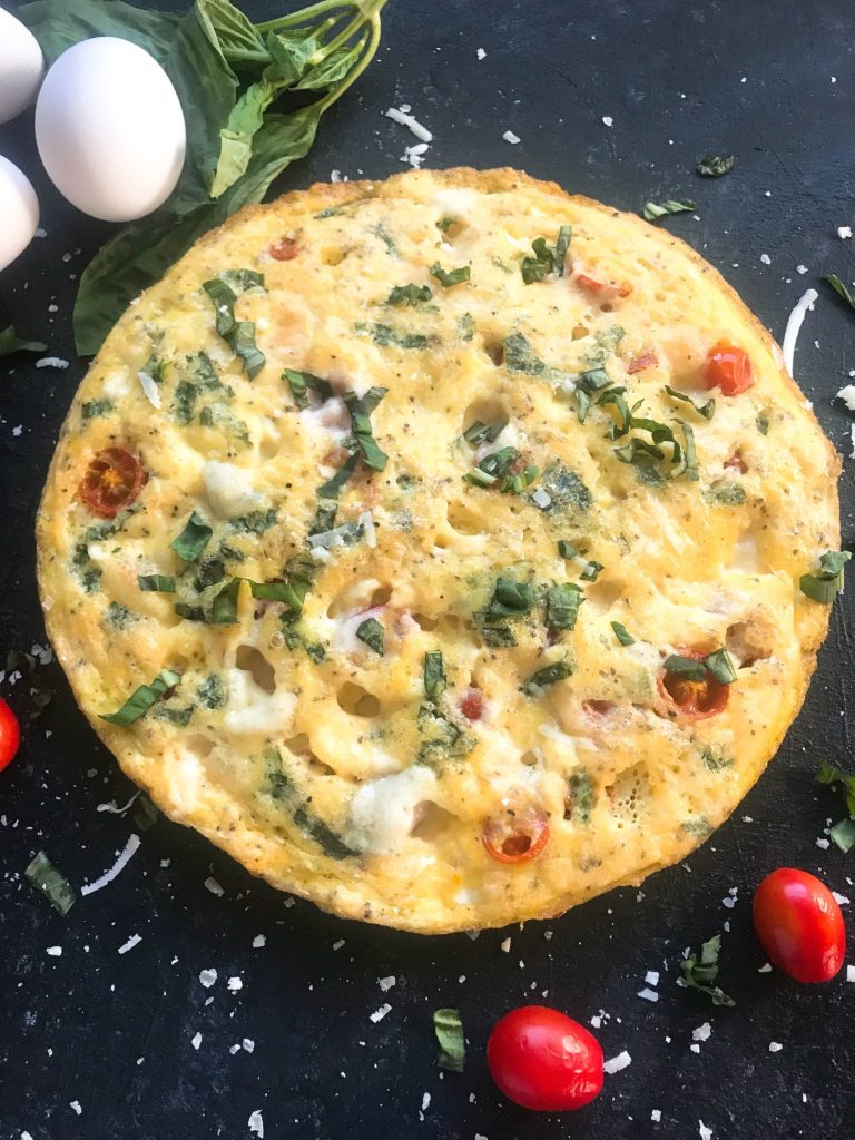 A fresh and bright frittata recipe ready in less than 30 minutes. Fresh cherry tomatoes, mozzarella cheese, and basil pack this egg frittata with flavor. Gluten free (GF) and vegetarian, a simple breakfast or brunch for a crown. Caprese Frittata | Three Olives Branch | www.threeolivesbranch.com 