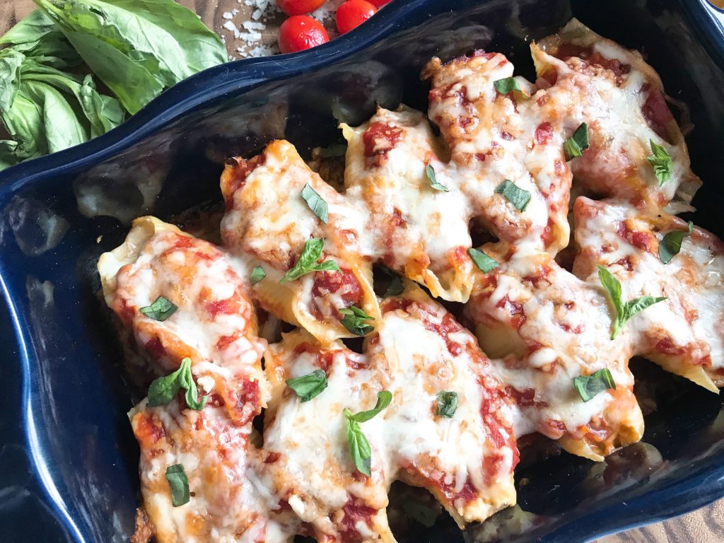 These stuffed shells are a fun twist on an Italian recipe classic! Cherry tomatoes, fresh basil, and mozzarella cheese are stuffed with chicken in pasta shells and baked in the oven. A great freezer meal and kid friendly. Chicken Caprese Stuffed Shells | Three Olives Branch | www.threeolivesbranch.com