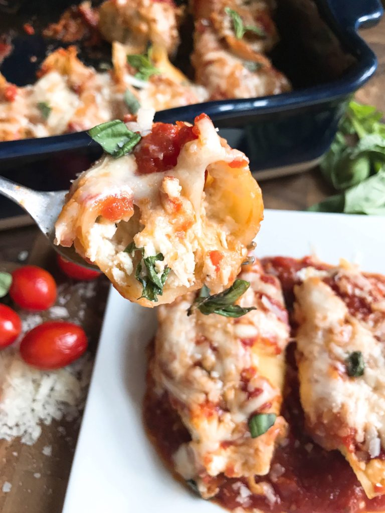 These stuffed shells are a fun twist on an Italian recipe classic! Cherry tomatoes, fresh basil, and mozzarella cheese are stuffed with chicken in pasta shells and baked in the oven. A great freezer meal and kid friendly. Chicken Caprese Stuffed Shells | Three Olives Branch | www.threeolivesbranch.com