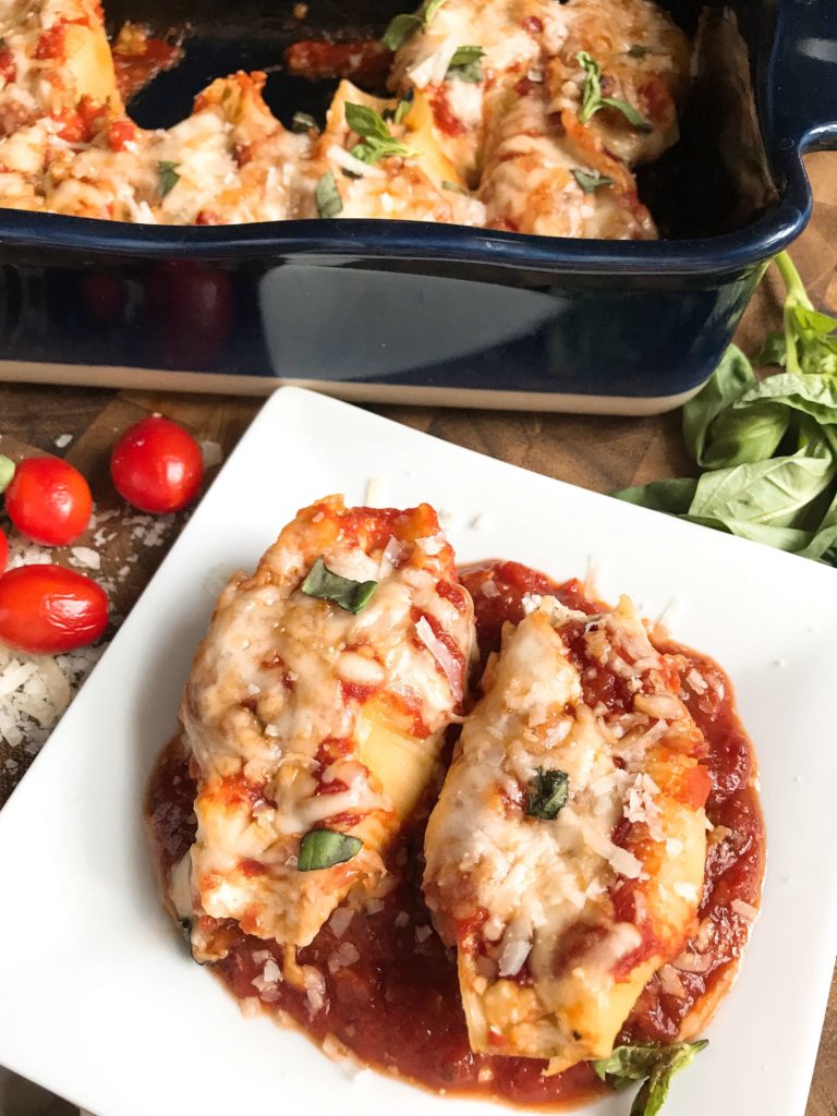 These stuffed shells are a fun twist on an Italian recipe classic! Cherry tomatoes, fresh basil, and mozzarella cheese are stuffed with chicken in pasta shells and baked in the oven. A great freezer meal and kid friendly. Chicken Caprese Stuffed Shells | Three Olives Branch | www.threeolivesbranch.com