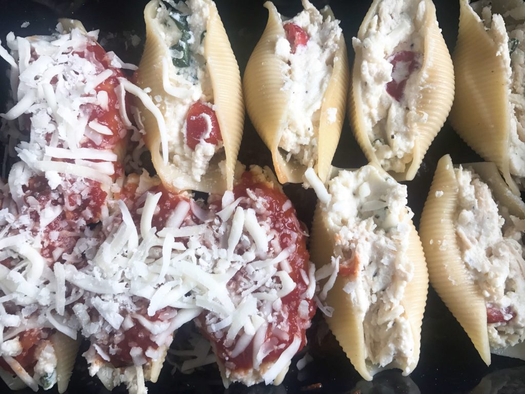 These stuffed shells are a fun twist on an Italian recipe classic! Cherry tomatoes, fresh basil, and mozzarella cheese are stuffed with chicken in pasta shells and baked in the oven. A great freezer meal and kid friendly. Chicken Caprese Stuffed Shells | Three Olives Branch | www.threeolivesbranch.com