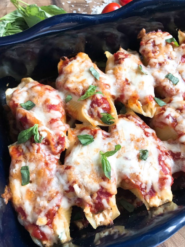 These stuffed shells are a fun twist on an Italian recipe classic! Cherry tomatoes, fresh basil, and mozzarella cheese are stuffed with chicken in pasta shells and baked in the oven. A great freezer meal and kid friendly. Chicken Caprese Stuffed Shells | Three Olives Branch | www.threeolivesbranch.com