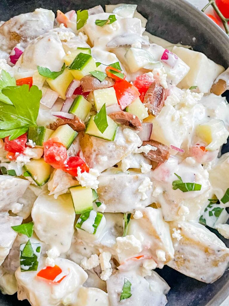 Close view of Greek Tzatziki Potato Salad in a gray bowl from the top