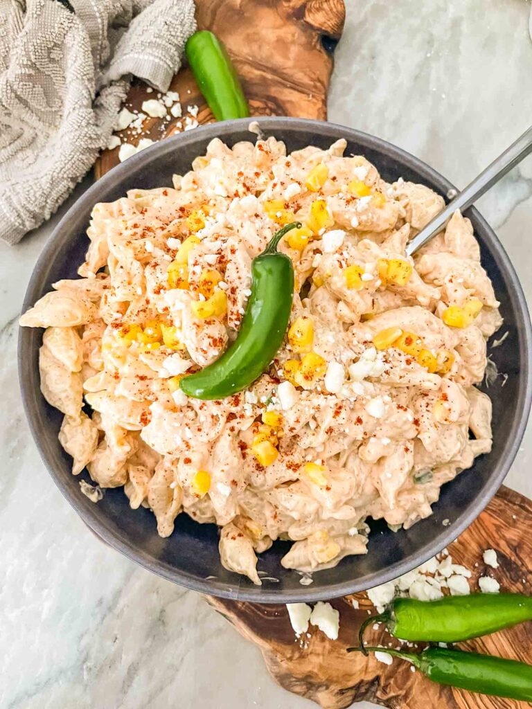 Mexican Street Corn Pasta Salad in a bowl with a spoon in it