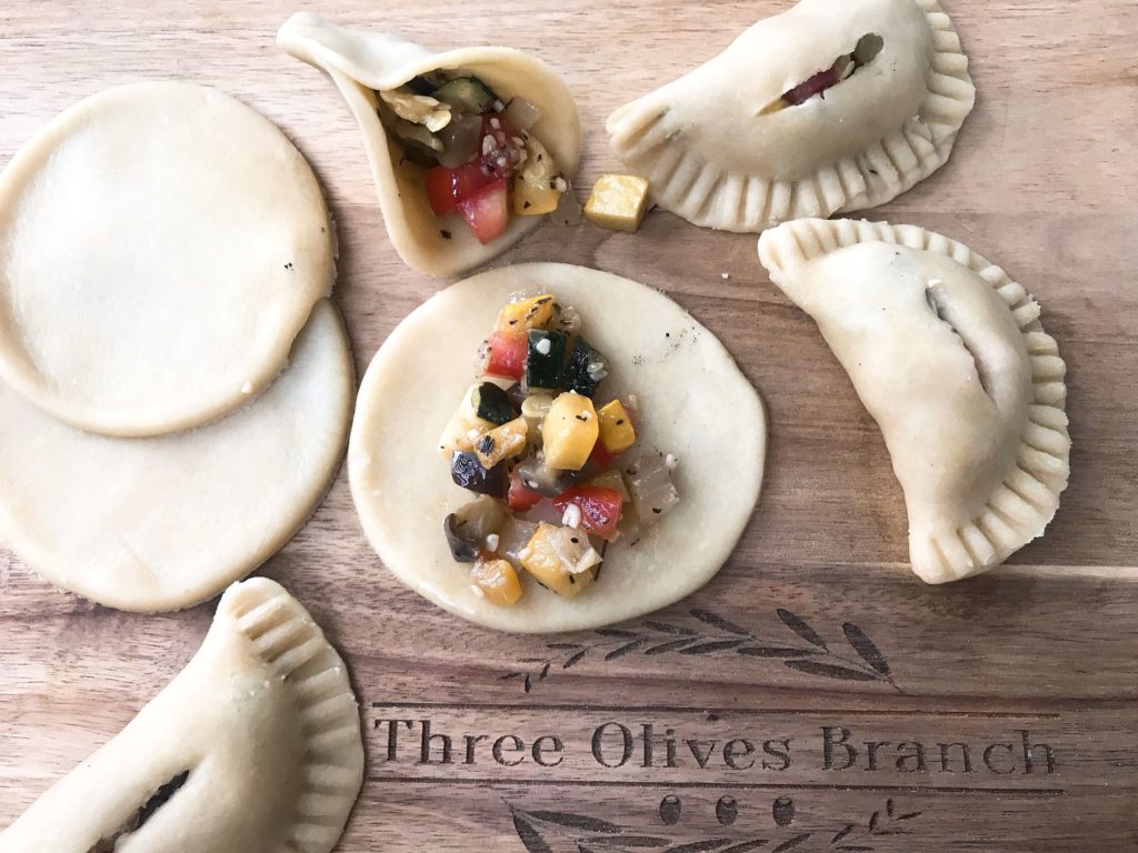 French inspired empanadas filled with eggplant, zucchini, squash, tomato, and onion. A great vegetarian recipe for party finger food or appetizers. Ratatouille Empanadas | Three Olives Branch | www.threeolivesbranch.com