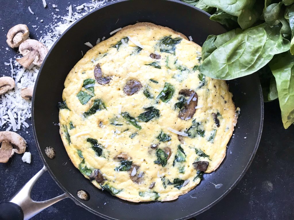 Ready in 20 minutes, a fast and simple breakfast or brunch recipe. Mushrooms, spinach, and cheese mixed in egg. Gluten free (gf). Vegetarian Spinach Florentine Frittata | Three Olives Branch | www.threeolivesbranch.com