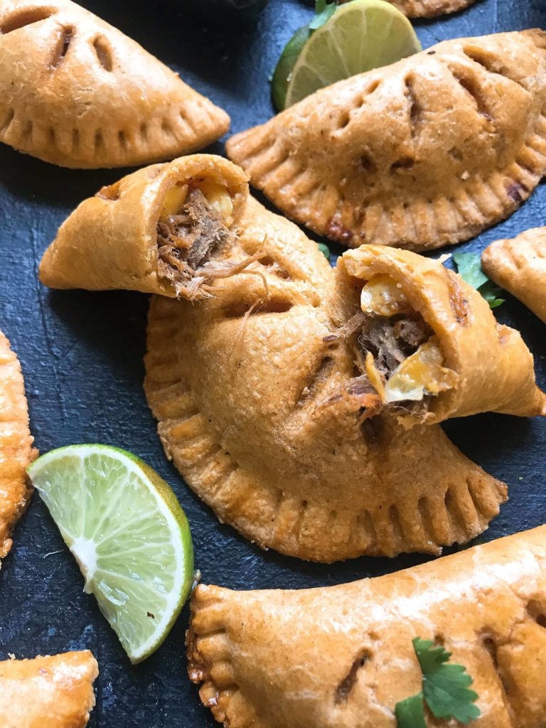 Empanadas stuffed with shredded beef and a Mexican Street Corn Salsa (elote) recipe of corn, cotija cheese, jalapeno, lime, chili powder, cilantro, and salt. A fun Mexican appetizer or snack. Use pie crust or make your own dough and leftover beef or steak if desired. Shredded Beef and Mexican Street Corn Empanadas | Three Olives Branch | www.threeolivesbranch.com #cincodemayo #fiesta