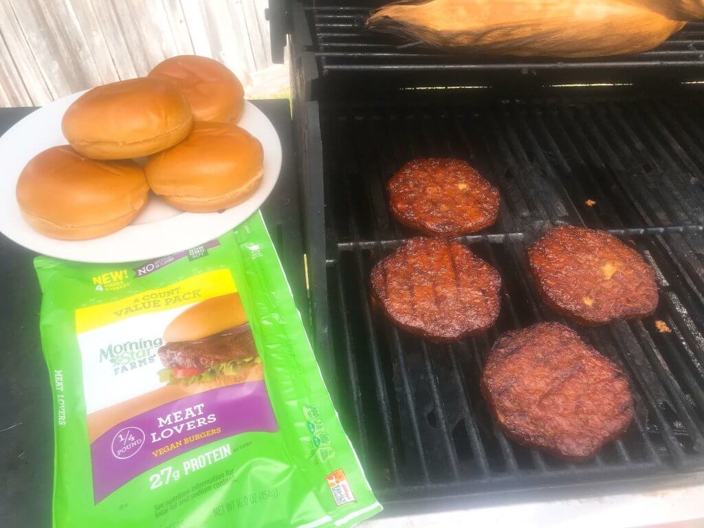 Vegan burgers topped with cucumber, olive tapenade, roasted red peppers, hummus, and spinach. Made with MorningStar Farms® Meat Lovers Burgers, these burgers are ready in just 20 minutes. Vegan Mediterranean Burgers #grilling #MorningStarFarms #MakeRoomOnYourGrill #ad