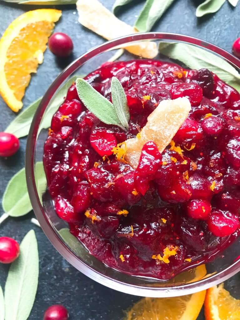 A quick and simple cranberry sauce recipe ready in 10 minutes. Flavored with ginger and orange, this sauce is vegetarian, vegan, and gluten free (GF). Perfect for Thanksgiving, Christmas, Easter, and holiday side dish. Make ahead! Ginger Orange Cranberry Sauce | Three Olives Branch | www.threeolivesbranch.com #thanksgiving #cranberrysauce #christmas