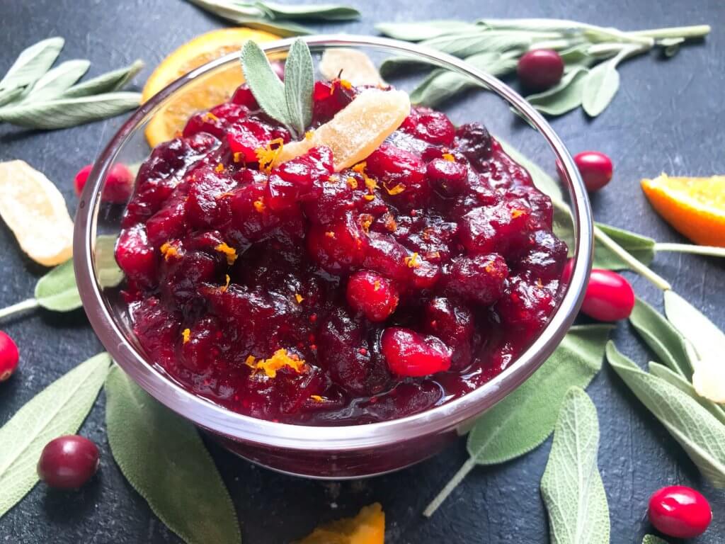 A quick and simple cranberry sauce recipe ready in 10 minutes. Flavored with ginger and orange, this sauce is vegetarian, vegan, and gluten free (GF). Perfect for Thanksgiving, Christmas, Easter, and holiday side dish. Make ahead! Ginger Orange Cranberry Sauce | Three Olives Branch | www.threeolivesbranch.com #thanksgiving #cranberrysauce #christmas