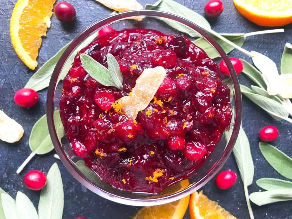 A quick and simple cranberry sauce recipe ready in 10 minutes. Flavored with ginger and orange, this sauce is vegetarian, vegan, and gluten free (GF). Perfect for Thanksgiving, Christmas, Easter, and holiday side dish. Make ahead! Ginger Orange Cranberry Sauce | Three Olives Branch | www.threeolivesbranch.com #thanksgiving #cranberrysauce #christmas